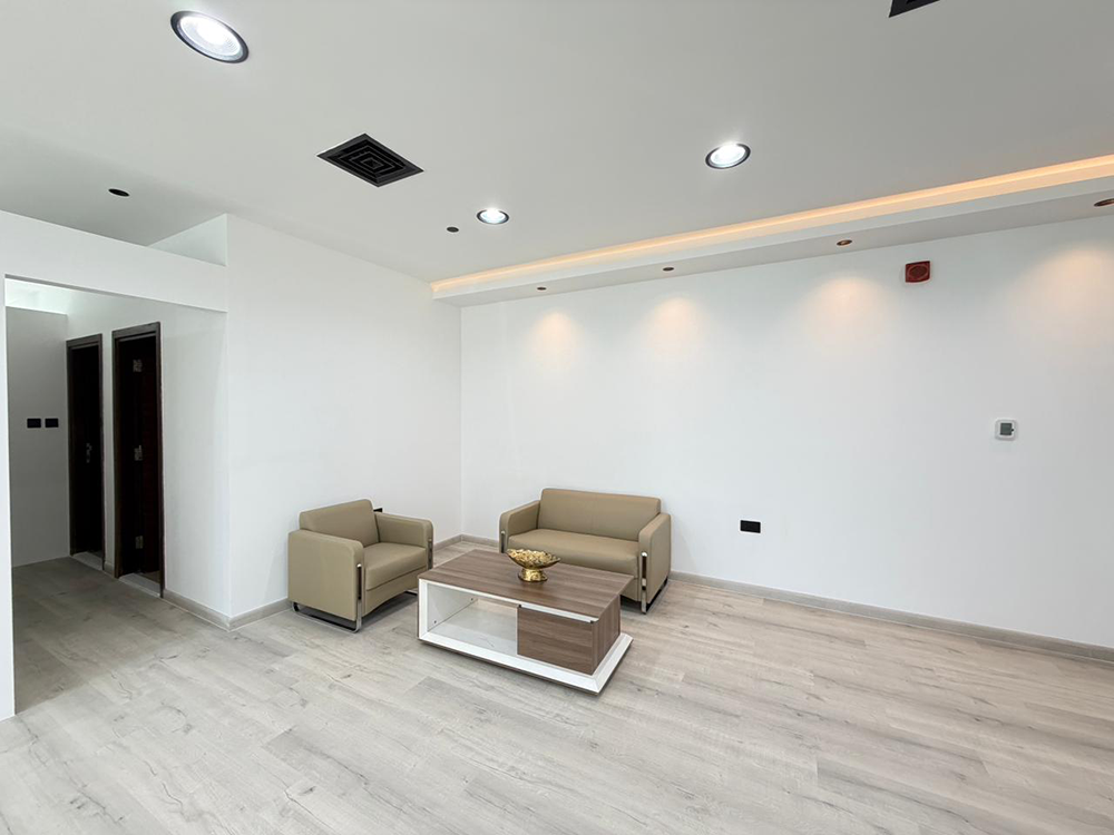Spacious working area with desks and chairs